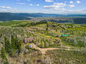 Aerial view of property and surrounding area featuring mountains