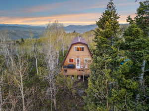 Rear view of house with a deck with mountain view