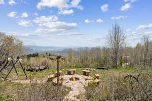View of yard with a fire pit and a mountain view