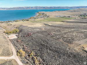 Aerial view of property and surrounding area with a water and mountain view