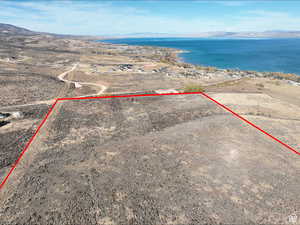 Aerial view of property's location featuring a water and mountain view and property parcel outlined