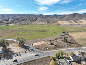 Aerial overview of property's location with rural landscape and a mountain backdrop