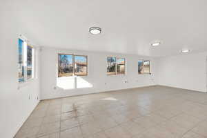 Spare room with light tile patterned floors