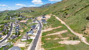 View of property location featuring a mountainous background and nearby suburban area