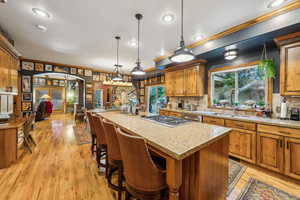 Kitchen with a sink, appliances with stainless steel finishes, tasteful backsplash, crown molding, and a center island