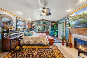 Bedroom featuring ornamental molding, a tiled fireplace, vaulted ceiling, baseboards, and recessed lighting