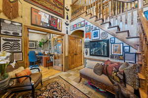 Living area featuring a high ceiling and a desk