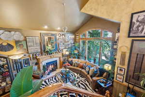 Living area with a chandelier, a tiled fireplace, and recessed lighting