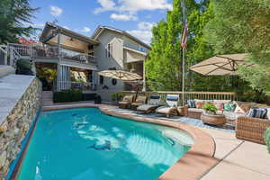 Outdoor pool with an outdoor hangout area, a ceiling fan, a deck, and a patio
