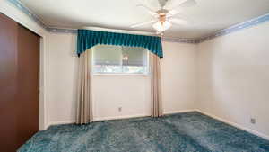 Unfurnished bedroom featuring carpet, ceiling fan, and baseboards