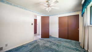 Unfurnished bedroom featuring carpet flooring, a closet, baseboards, and ceiling fan