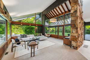 Sunroom / solarium featuring carpet, an outdoor hangout area, beamed ceiling, and high vaulted ceiling
