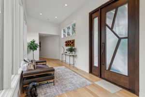Entrance foyer with light wood-style flooring, recessed lighting, and baseboards