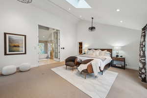 Bedroom with a skylight, vaulted ceiling, light colored carpet, recessed lighting, and baseboards