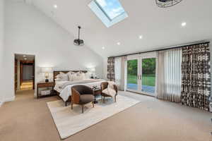 Bedroom featuring access to outside, carpet floors, high vaulted ceiling, recessed lighting, and a skylight