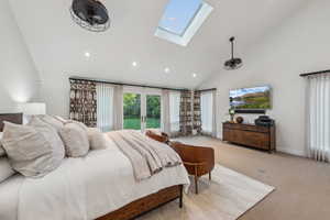 Carpeted bedroom with a skylight, recessed lighting, and high vaulted ceiling