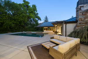 Outdoor pool with an outdoor hangout area and a patio