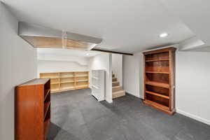 Finished basement featuring recessed lighting, stairway, and baseboards
