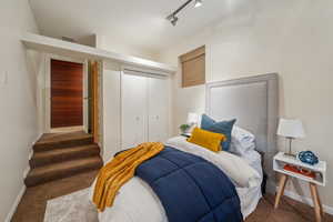 Bedroom with carpet flooring, baseboards, and a closet