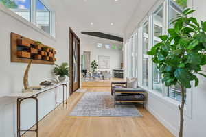 Living area featuring wood finished floors, recessed lighting, and baseboards