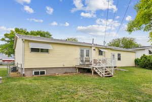 Back of house with cooling unit and a gate