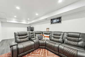 Cinema with wood finished floors, recessed lighting, and baseboards