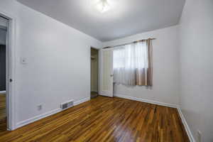 Unfurnished bedroom with baseboards, wood finished floors, and a closet