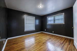 Empty room with wood finished floors and baseboards
