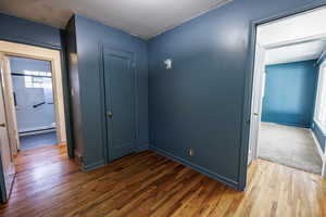 Corridor featuring wood finished floors and baseboards