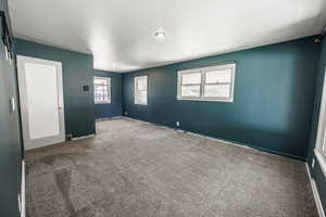Empty room with carpet and baseboards