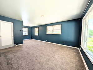Carpeted spare room with baseboards