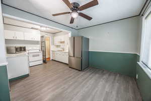 Kitchen featuring appliances with stainless steel finishes, a sink, light wood-type flooring, and plenty of natural light