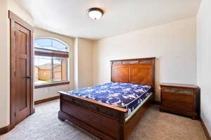 Bedroom with light carpet and baseboards