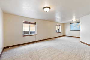 Carpeted empty room with baseboards