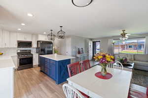 Dining space with light wood finished floors, recessed lighting, and ceiling fan