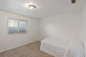 Carpeted bedroom with baseboards