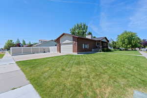 View of front of house featuring brick siding, concrete driveway, a chimney, and an attached garage