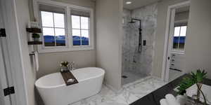 Bathroom with light marble finish floors, a mountain view, a marble finish shower, and a soaking tub