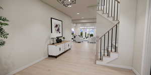 Entryway featuring stairway, light wood-type flooring, recessed lighting, and a chandelier