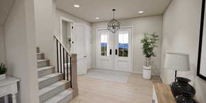 Foyer with light wood finished floors, stairs, recessed lighting, french doors, and a chandelier