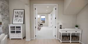 Corridor with light wood-style flooring and recessed lighting