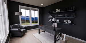 Office area featuring light wood finished floors, a mountain view, and recessed lighting