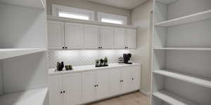Detailed view of backsplash and wood finished floors
