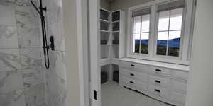 Walk in closet with light carpet