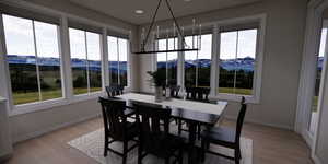 Dining space featuring a mountain view, light wood-style floors, and recessed lighting
