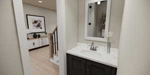 Half bathroom with vanity, light wood-style flooring, and recessed lighting