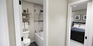 Full bathroom featuring ensuite bath, enclosed tub / shower combo, and dark tile patterned floors