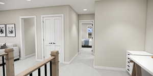 Hallway featuring light colored carpet and recessed lighting