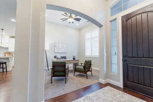Entrance foyer featuring dark wood-type flooring, ceiling fan, arched walkways, baseboards, and recessed lighting
