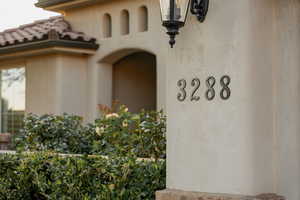 Property entrance with a tile roof and stucco siding